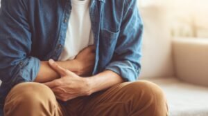 Man holding his abdomen like he is in pain