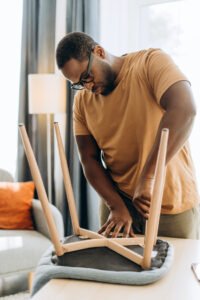 Man repairing a chair in Pam Rumley's World
