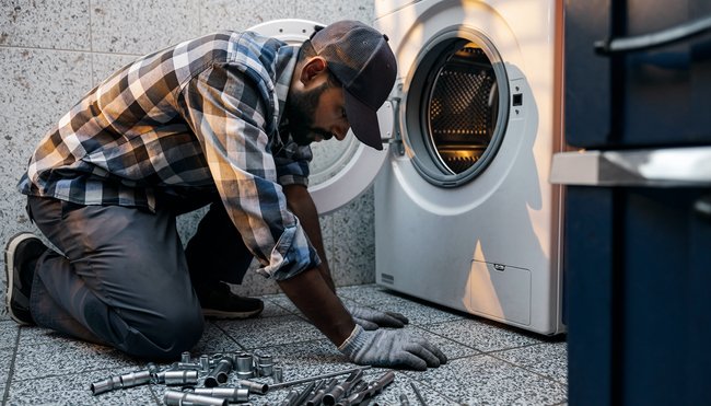 Man working on a Washing Machine