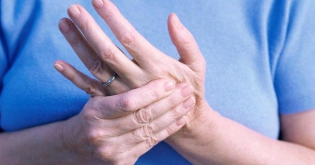 senior woman rubbing cold hands showing a possible sign of poor circulation