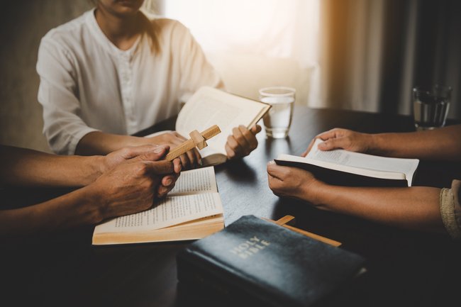 group of men studying the Bible together representing faith discussion and spiritual growth